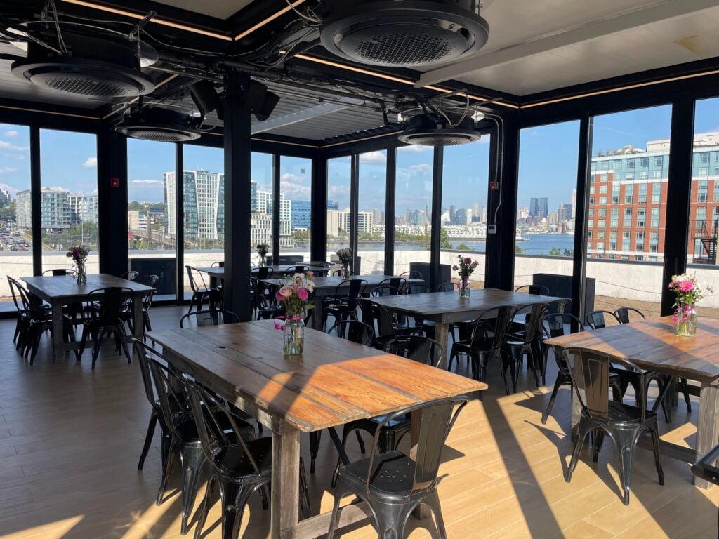 Hudson Table enclosed rooftop dining with skyline views